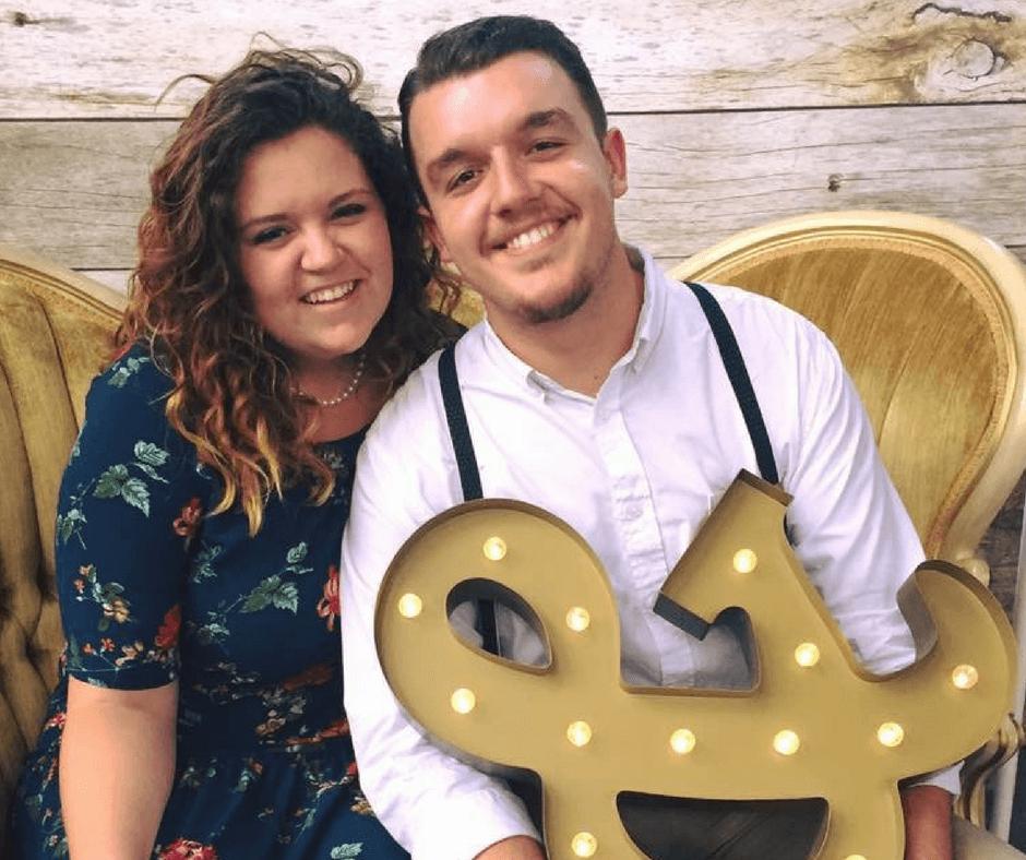 smiling on vintage couch with "and" symbol